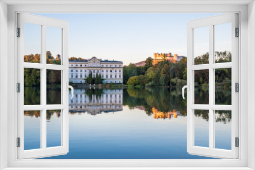Fototapeta Naklejka Na Ścianę Okno 3D - Beautiful sunset colors in Leopoldskroner Weiher Lake with Leopoldskron Palace and Hohensalzburg Fortress in the background - Salzburg, Austria 