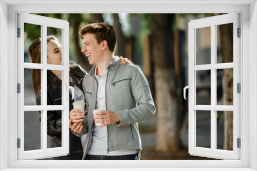 Young happy beautiful couple walking in the street.