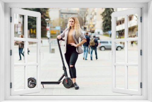 Girl in electric scooter riding in the old city center