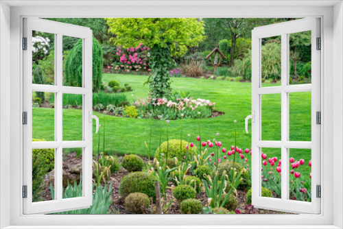 Fototapeta Naklejka Na Ścianę Okno 3D - Zielony ogród pełen kwitnących kiatów