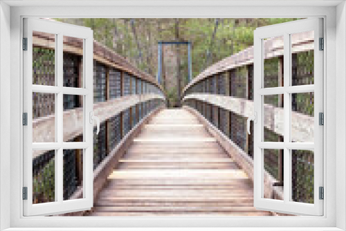 Fototapeta Naklejka Na Ścianę Okno 3D - Wooden suspension bridge in the forest
