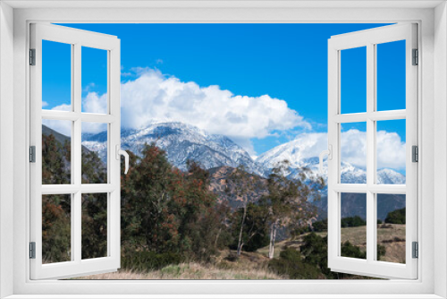 Fototapeta Naklejka Na Ścianę Okno 3D - snow topped mountains with clouds and blue sky