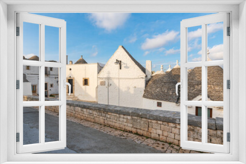 Fototapeta Naklejka Na Ścianę Okno 3D - Malownicze miasteczko we Włoszech z pięknymi domkami - Alberobello