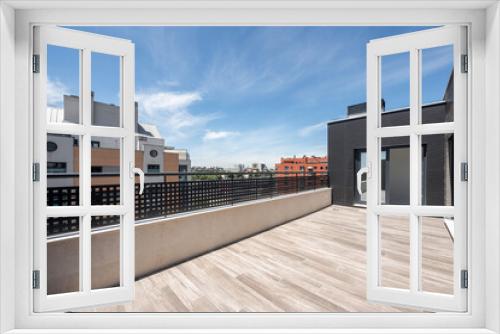 Fototapeta Naklejka Na Ścianę Okno 3D - large terrace on a penthouse with clear skies and a large glass door in the background