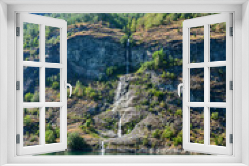 Fototapeta Naklejka Na Ścianę Okno 3D - A waterfall in a stunning setting along the Sognefjord between the villages of Flam and Gudvangen in Norway