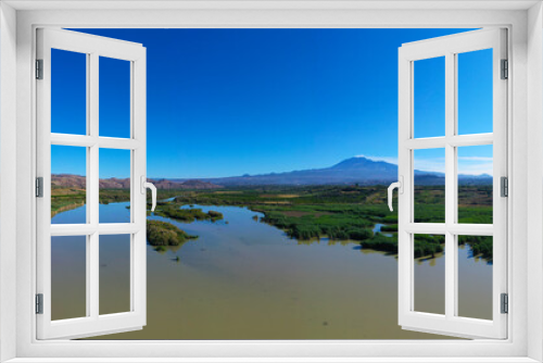 Fototapeta Naklejka Na Ścianę Okno 3D - 180 degrees aerial photo of the Oasis of Ponte Barca a protected area in the heart of Paternò in Sicily. Wetland that attracts numerous waterfowl. Nesting place of the Sultan chicken. Etna view.