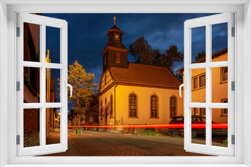 Fototapeta Naklejka Na Ścianę Okno 3D - View of the historic protestant church of Walldorf in hesse during sunset