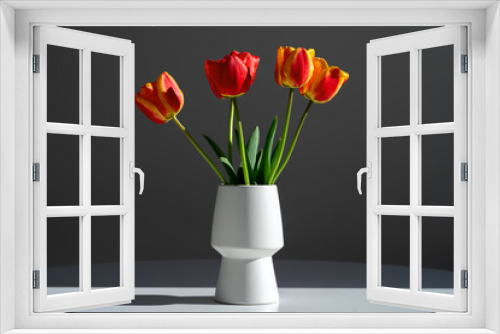 Fototapeta Naklejka Na Ścianę Okno 3D - Bouquet of five tulips in a white vase on a gray background.