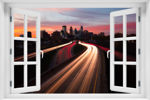 Fototapeta Naklejka Na Ścianę Okno 3D - Minneapolis skyline at sunset from the pedestrian bridge with light trails on highway