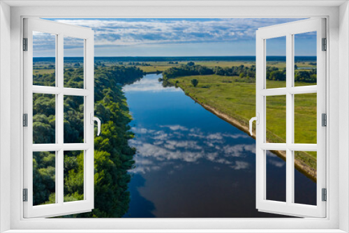 Fototapeta Naklejka Na Ścianę Okno 3D - Aerial  view of a beautiful summer  landscape over river while dawn. Top view over river with a smooth water surface reflecting blue sky and clouds.