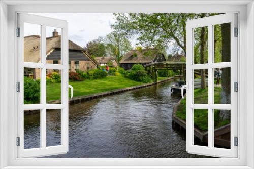 Fototapeta Naklejka Na Ścianę Okno 3D - view of the picturesque village of Giethoorn in the Netherlands with ist quaint houses and many canals