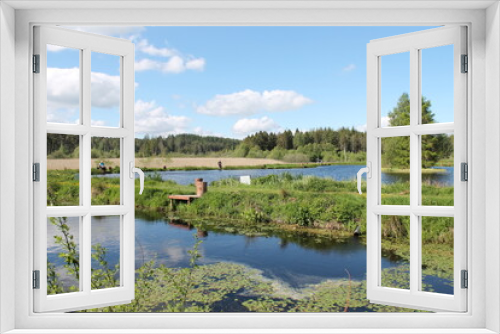 Fototapeta Naklejka Na Ścianę Okno 3D - Scenic view of two fishing lakes on a bright sunny day