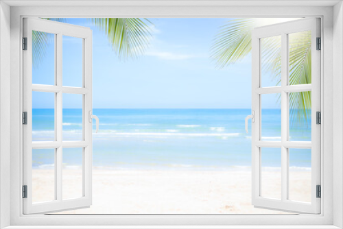 Fototapeta Naklejka Na Ścianę Okno 3D - Sand beach soft wave with coconut or palm leaves at coast with blue sea and blue sky. nature ocean outdoor. tropical tourist vacation summer travel in holidays concept.