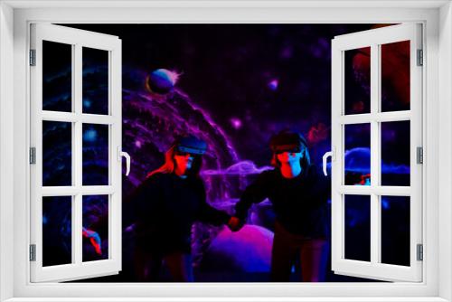 Fototapeta Naklejka Na Ścianę Okno 3D - Two girls friends in virtual glasses are holding hands in the playroom in neon light
