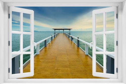 Fototapeta Naklejka Na Ścianę Okno 3D - Sea or nature background with sunset and sky at twilight. Perspective view of wood bridge and pavilion. Asia travel destination in Chonburi of Thailand called Bangsaen Beach for holiday and vacation.