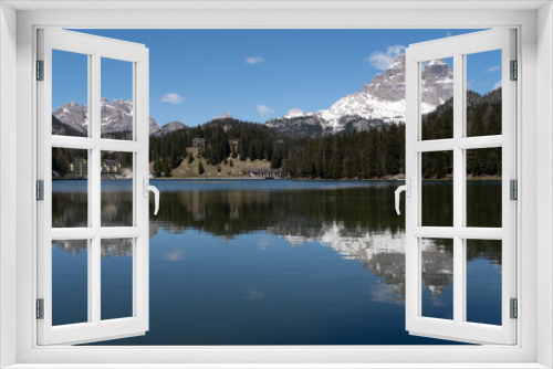 Fototapeta Naklejka Na Ścianę Okno 3D - Misurina, Italy - May 31, 2021: The fabulous alpine lake in the Dolomites. Lovely and relaxing place in the Italian Alps. Reflections in the rippled water. Sunny spring day.