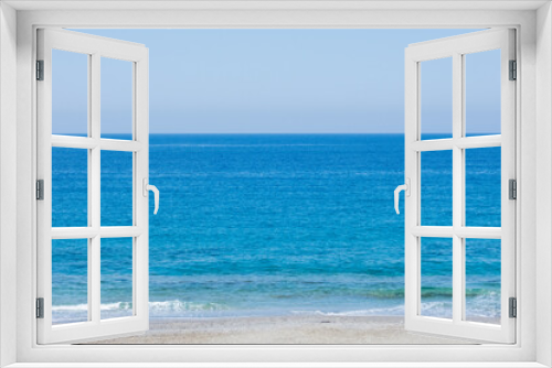 Fototapeta Naklejka Na Ścianę Okno 3D - Bright blue mediterranean sea with strip of beach on sunny summer day