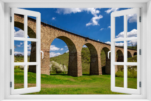 Fototapeta Naklejka Na Ścianę Okno 3D - Old railway stone viaduct in the spring in sunny day.