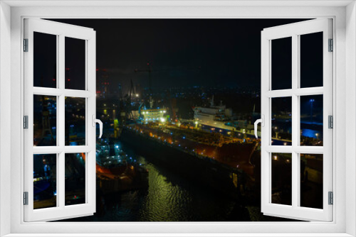 Fototapeta Naklejka Na Ścianę Okno 3D - Air night panorama Remontova shipyard  with ships in to dry docks. Poland, Gdansk, drone footage, natural light.