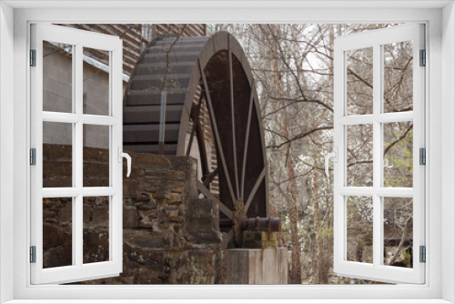 Fototapeta Naklejka Na Ścianę Okno 3D - Old wooden waterwheel on a mill