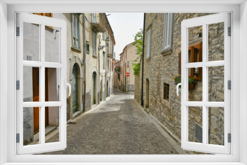 Fototapeta Naklejka Na Ścianę Okno 3D - A small street between the old houses of Agnone, a medieval village in the mountains of Molise region in Italy.