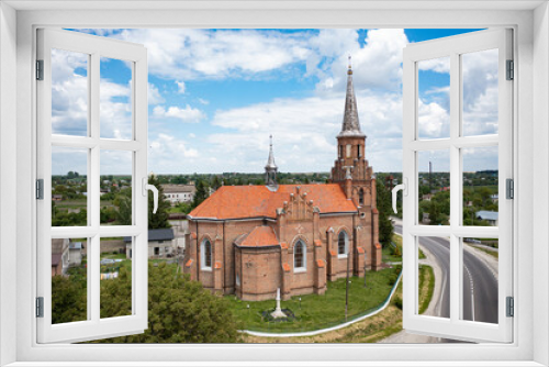 Fototapeta Naklejka Na Ścianę Okno 3D - Neo-Gothic Catholic Church of the Sacred Heart of Jesus in Stoyaniv, Ukraine. Aerial view from drone