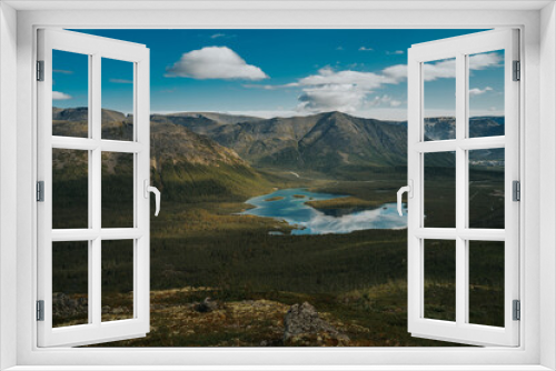 Fototapeta Naklejka Na Ścianę Okno 3D - Beautiful blue lake with a reflection of the sky in valley on the background mountain picks  in cloudy weather in polar summer, top view. Arctic, Kola Peninsula 