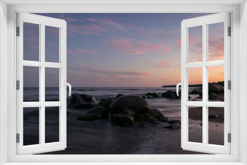 Fototapeta Naklejka Na Ścianę Okno 3D - rocky sea shore before sunrise, dark stone silhouettes and colorful sky