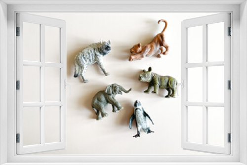 Fototapeta Naklejka Na Ścianę Okno 3D - Figures of animals on a white background Children's toys: rhino, hippopotamus, zebra. The concept of children's play, montessori. many pieces to play. A gift for a child. Animal protection.