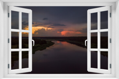 Fototapeta Naklejka Na Ścianę Okno 3D - Beautiful, fascinating sunset with clouds over a lake, a river on a summer evening, view from a drone