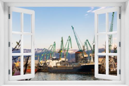 Fototapeta Naklejka Na Ścianę Okno 3D - View of berthing line of Batumi Sea trade Port with cargo cranes and loading barges on sunny spring day, Georgia.