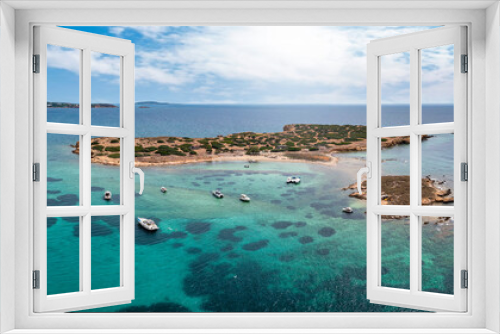 Fototapeta Naklejka Na Ścianę Okno 3D - The little island Ydrousa off the coast of Voula, south Athens, Greece, with turquoise sea and a beautiful beach next to moored boats