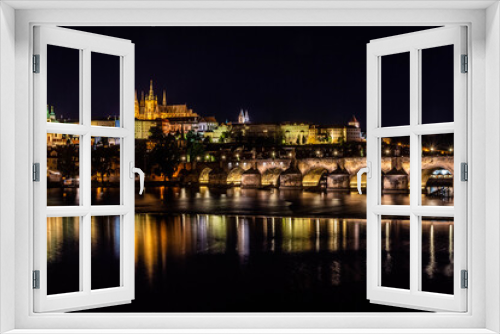 PRAGUE, CZECH REPUBLIC, 31 JULY 2020: beautiful reflection of the Castle of Prague and the Charles Bridge at night