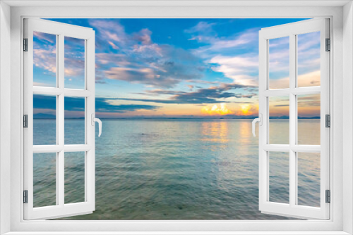 Fototapeta Naklejka Na Ścianę Okno 3D - Nature in twilight period which including of sunrise over the sea and the nice beach. Summer beach with blue water and purple sky at the sunset.	
