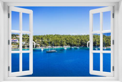 Fototapeta Naklejka Na Ścianę Okno 3D - Aerial photo of sailing boats docked in blue bay of Fiskardo, Kefalonia island, Ionian, Greece