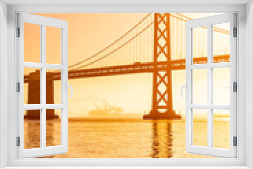 Fototapeta Naklejka Na Ścianę Okno 3D - Incredible view of the Oakland Bay Bridge and the waterfront in San Francisco at sunrise, photographed from the pier