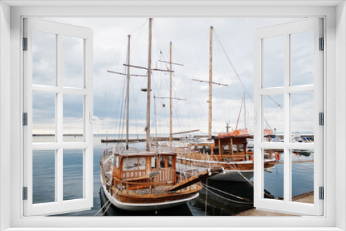 Fototapeta Naklejka Na Ścianę Okno 3D - Two wooden old sailing ship stay on dock.