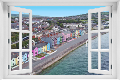 Fototapeta Naklejka Na Ścianę Okno 3D - Yellow Red Orange Green Blue sky houses by the sea aerial Whitehead N. Ireland