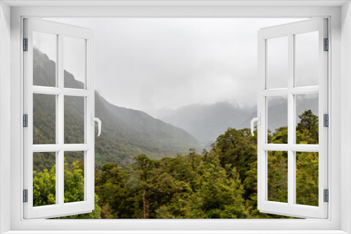 Fototapeta Naklejka Na Ścianę Okno 3D - Impressive rainforest and mountains surrounded by beautiful clouds, Milford Sound highway, New Zealand