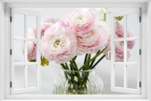 Fototapeta Naklejka Na Ścianę Okno 3D - the bouquet of pale pink Persian buttercups in the glass vase on the table against the background .