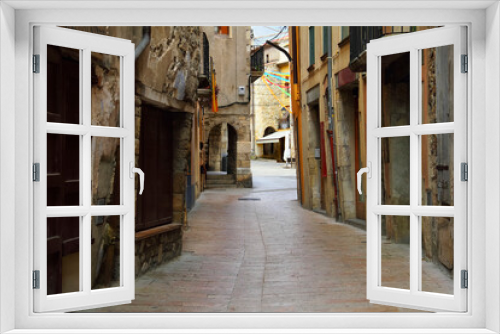 Fototapeta Naklejka Na Ścianę Okno 3D - Traditional european cityscape - ancient gothic quarter with a cobbled narrow winding street and overhanging walls of houses in Besalu, Girona, Catalonia, Spain, South Europe