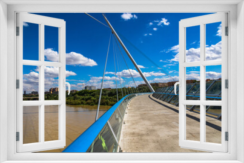 Fototapeta Naklejka Na Ścianę Okno 3D - pedestrian suspension bridge over the Ebro river in Zaragoza, Spain on a summer day