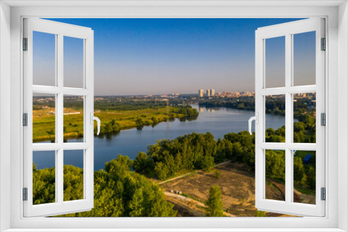 Fototapeta Naklejka Na Ścianę Okno 3D - panoramic view of a green residential area near the lake filmed from a drone 