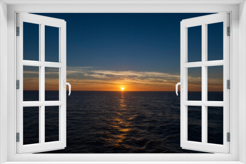 Sunset at sea. Seascape, blue sea.  Calm weather. View from cargo vessel.