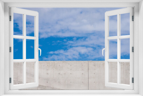 Fototapeta Naklejka Na Ścianę Okno 3D - 打ち放しコンクリートの壁と青空