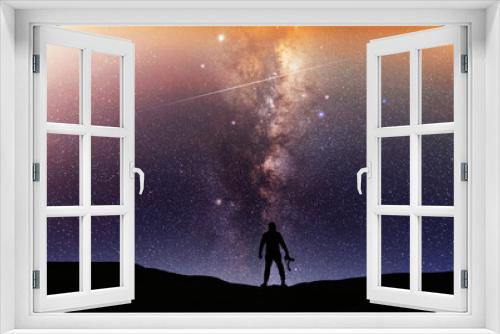 Fototapeta Naklejka Na Ścianę Okno 3D - Beautiful starry night, man silhouette with a camera looking at the Milky Way galaxy. Night landscape, astronomical background.