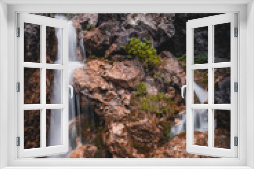 Fototapeta Naklejka Na Ścianę Okno 3D - Waterfall in the mountains in spring with refreshing splashes