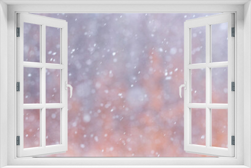 Abstract Christmas background with snowflakes during snowfall on blurred background