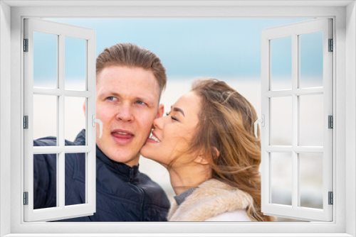 Beautiful young happy woman hugging cuddle young boyfriend while taking selfie photo on sunny beach.Close up.