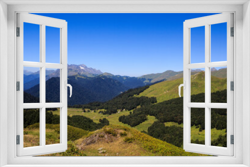 Fototapeta Naklejka Na Ścianę Okno 3D - landscape view with rocky mountains covered with snow greenforest and alpine meadows in caucasus mountains